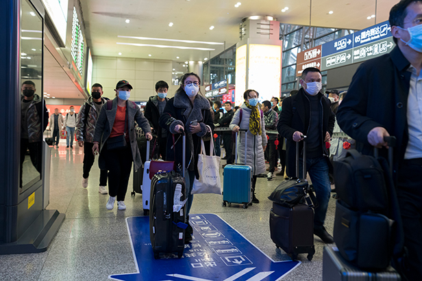 Travelers wearing protective masks