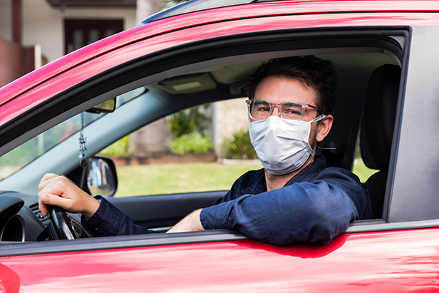 Man in car wearing a face mask