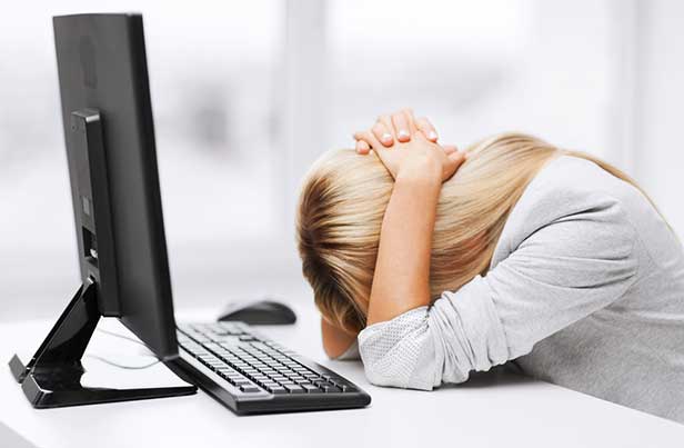 Young woman frustrated at her desk