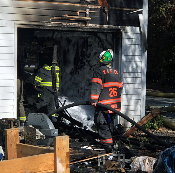 Fireman putting out fire at a house