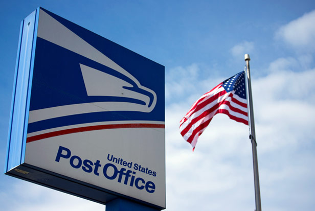 USPS sign next to US flag