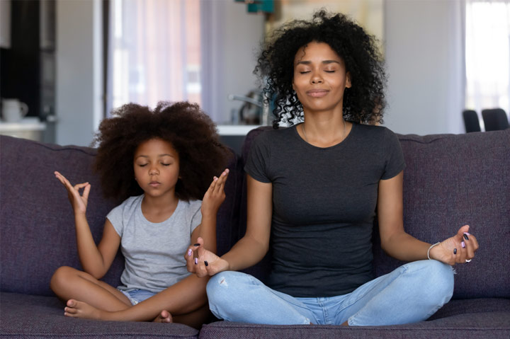 Mother and daughter meditating