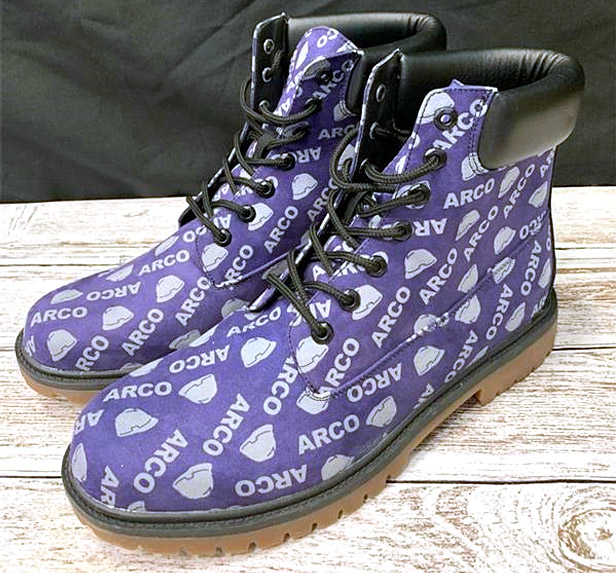 Purple hiking boots covered with Arco logos
