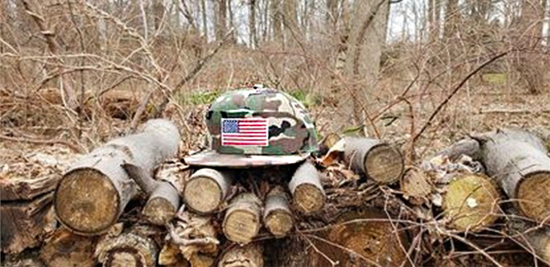 Camo hat on pile of wood