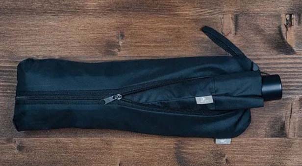 The carrying case of this mini-umbrella from PS Concepts converts into a reusable shopping bag