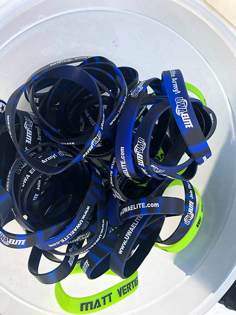 Wrestlers and fans alike sport UWA Elite branded wristbands to show their support.