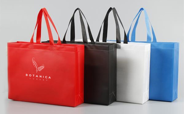 four different colored tote bags