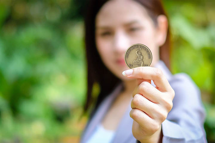 Young woman holding coin