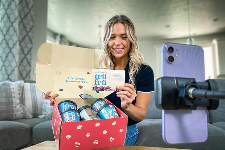 Young lady filming an unboxing video