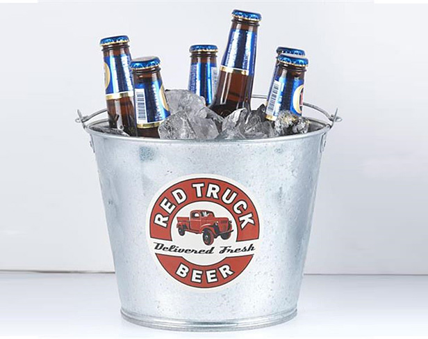 metal ice bucket filled with ice and beer