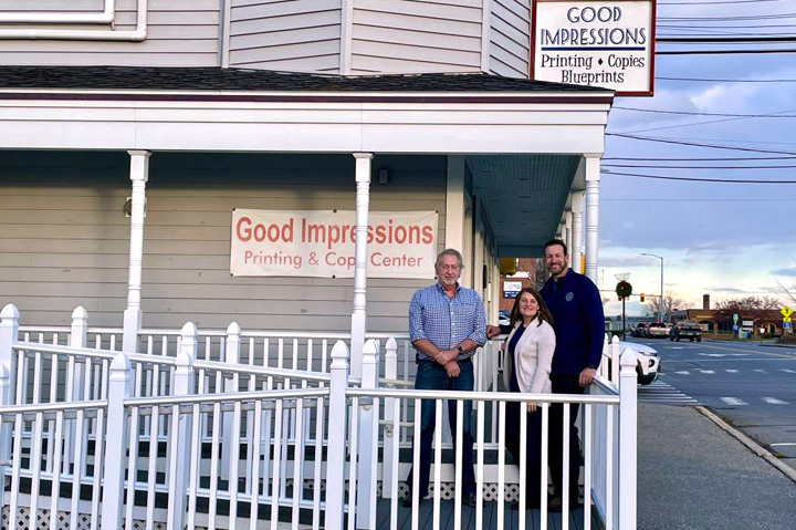 Adventure Advertising owners outside shop in Maine