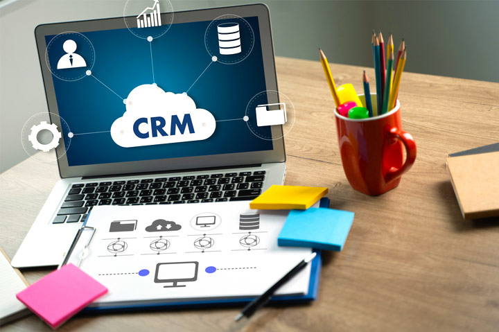 CRM on laptop screen on desk