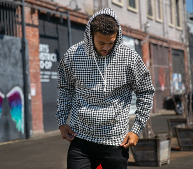 man wearing black and white houndstooth-pattern hoodie