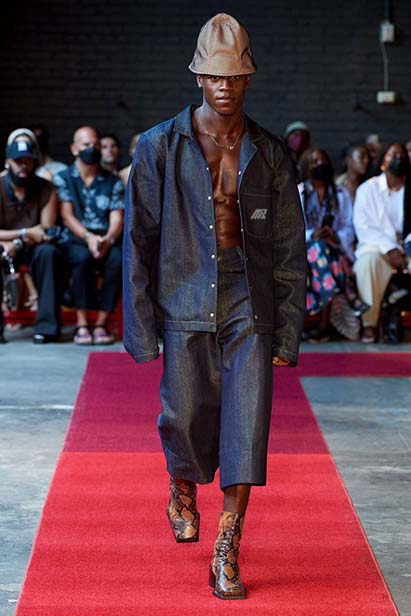 man in denim outfit on fashion runway