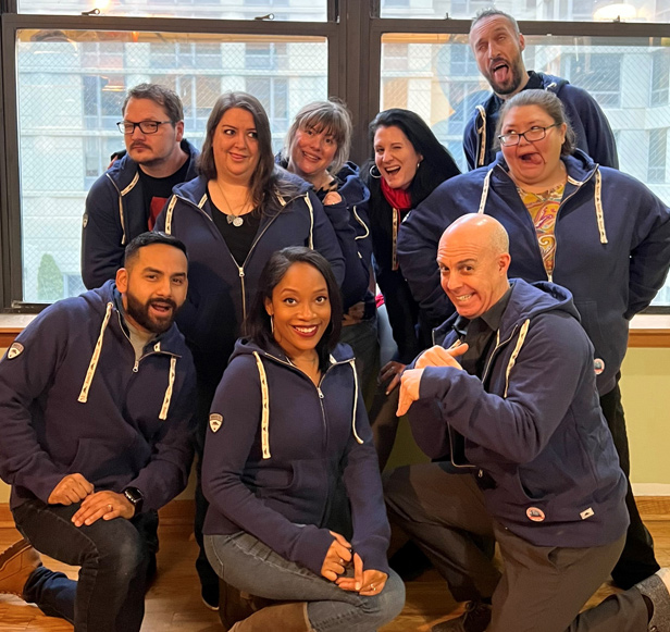 Printable Promotions employees posing in front of window