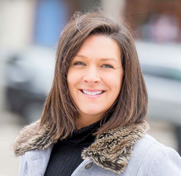 Nancy Schmidt, smiling wearing faux fur-lined jacket