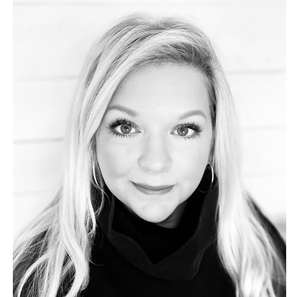 b&w photo of Stacy Price, blonde woman wearing black turtleneck and hoop earrings