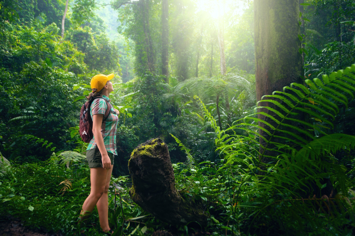 woman backpacking in forest