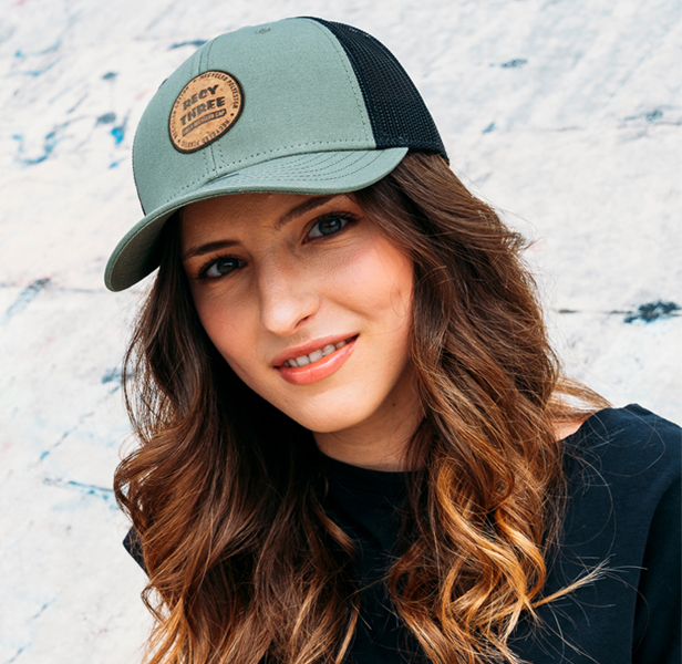 woman smiling, wearing baseball cap