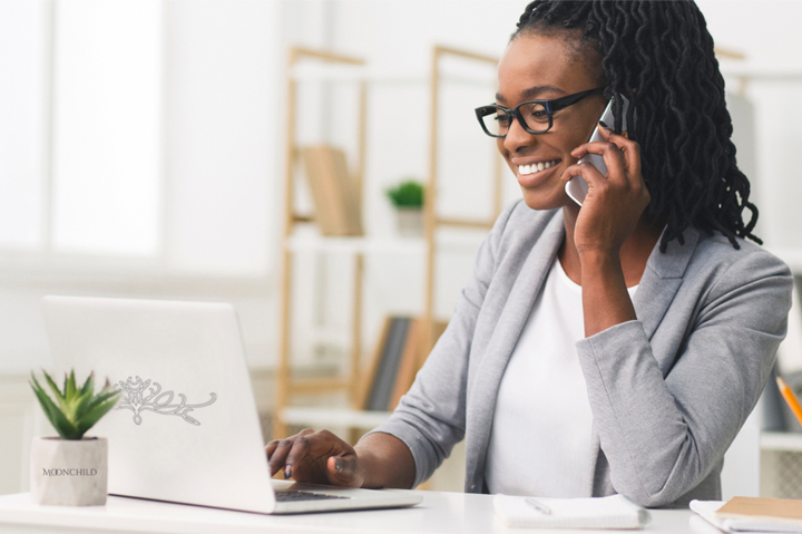 African America woman on phone and laptop