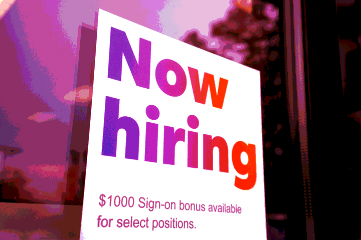 Now Hiring sign in window