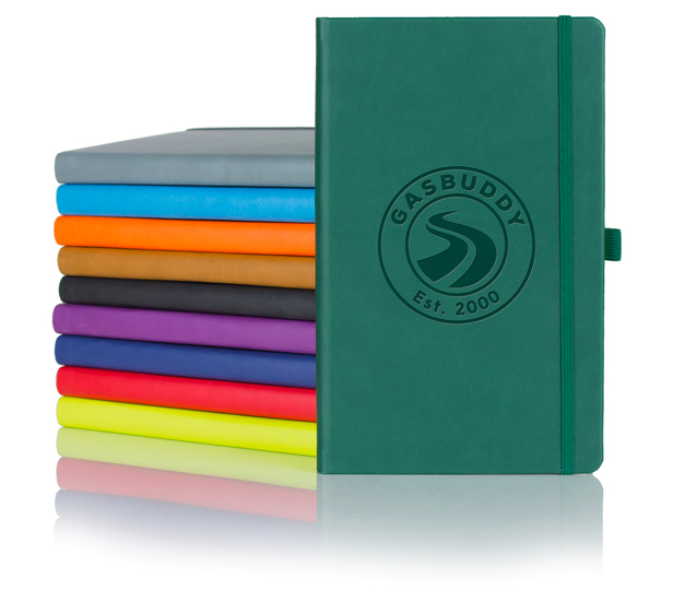 colorful journals stacked, green in front