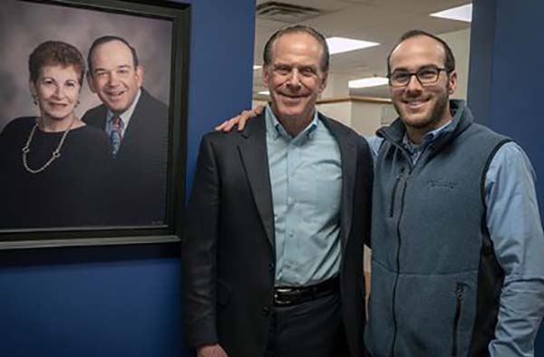 Gerry Barker, left, president of Barker Specialty, and Max Barker, account executive. Gerry’s parents, Herbert and Gloria Barker, are pictured on the photograph on the wall.