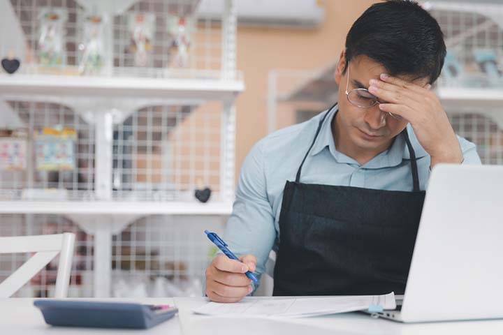 Young small-business owner struggling to pay bills