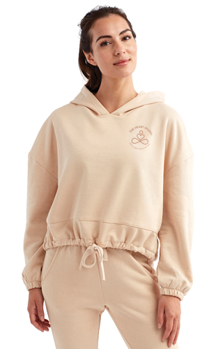 woman wearing beige cropped hoodie and matching pants