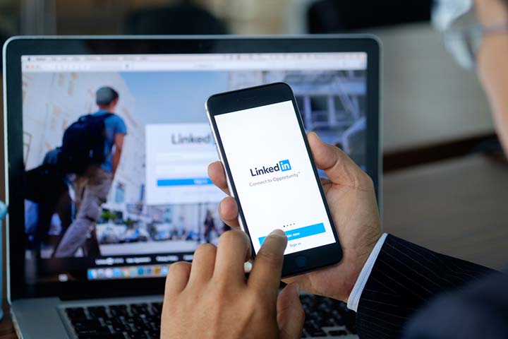 LinkedIn on phone and laptop