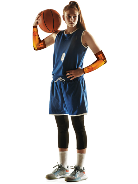 young teen girl wearing basketball jersey and shorts, holding basketball