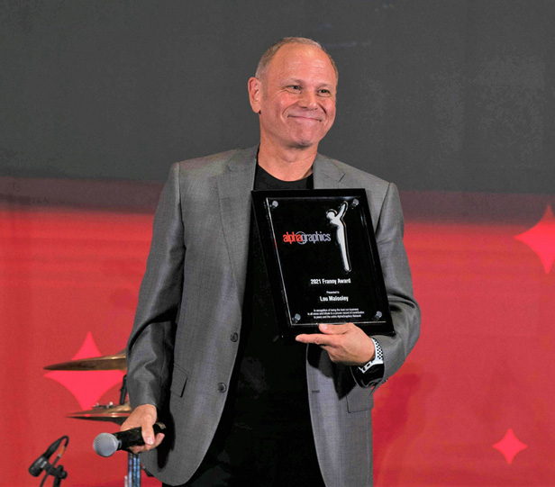 Louis Malooley holding award