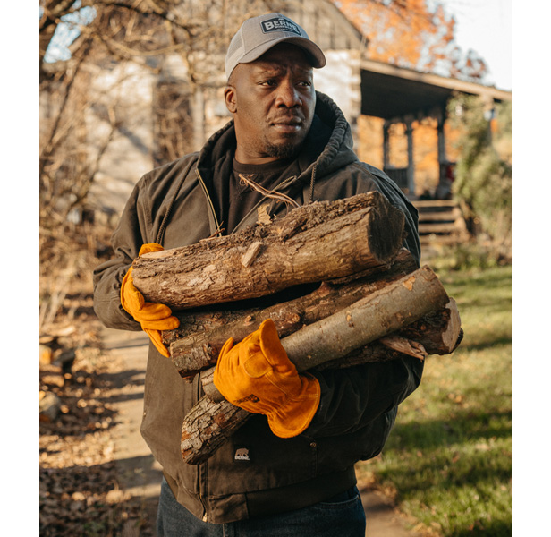 man carrying firewood