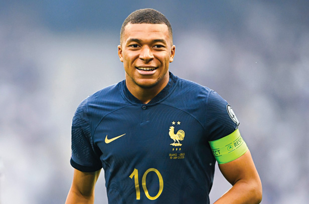 Kylian Mbappe, French soccer player wearing blue uniform, smiling