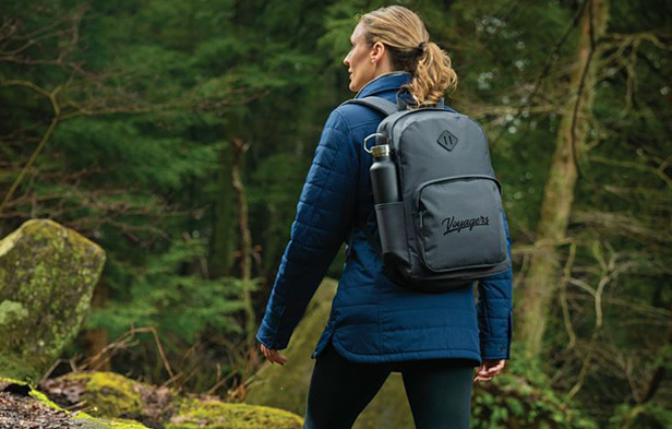 woman hiking in forest wearing backpack