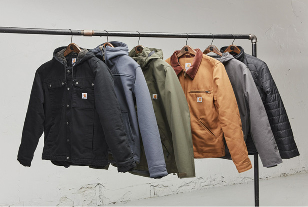 Carhartt jackets hanging on metal rack