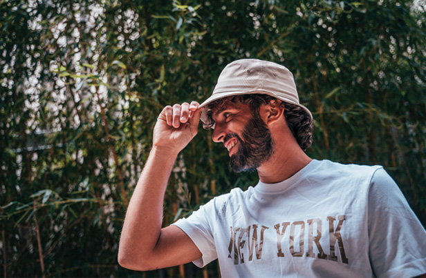 man wearing bucket hat, smiling