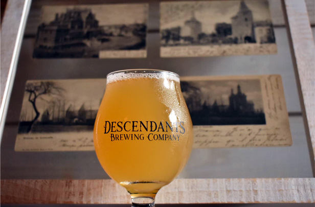 Descendants Brewing Co. goblet full of beer