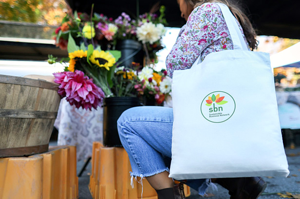 woman holding a reusable tote bag